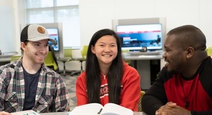 Students with book and laptop