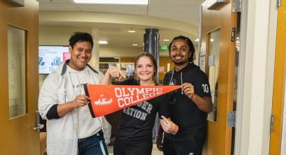 Three Students with Banner