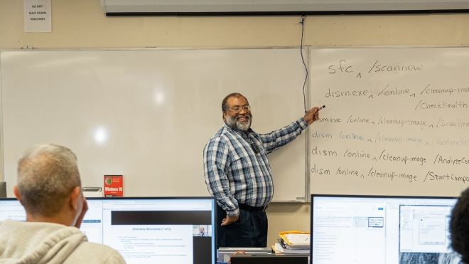 OC Professor Kevin Blackwell teaching a class, with two students in the foreground