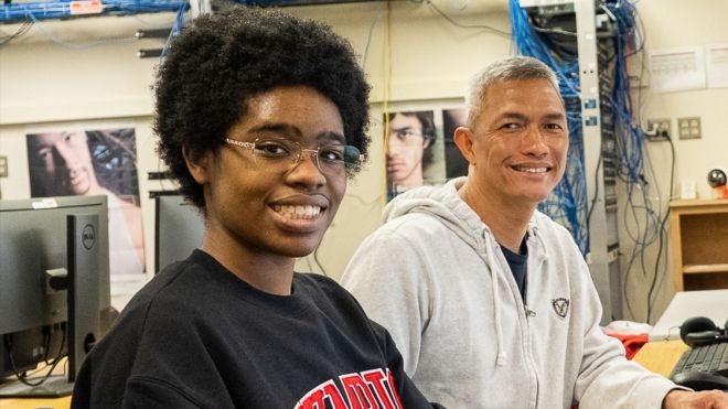 Two students in computer lab. 