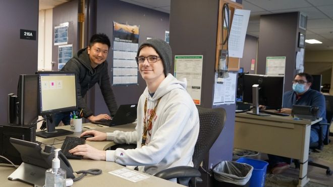 IT Help Desk staff sitting at computer