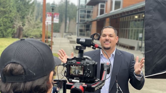 Student outdoors at Poulsbo Campus and posing for camera