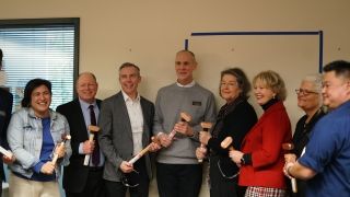 Speakers gather with commemorative sledgehammers.