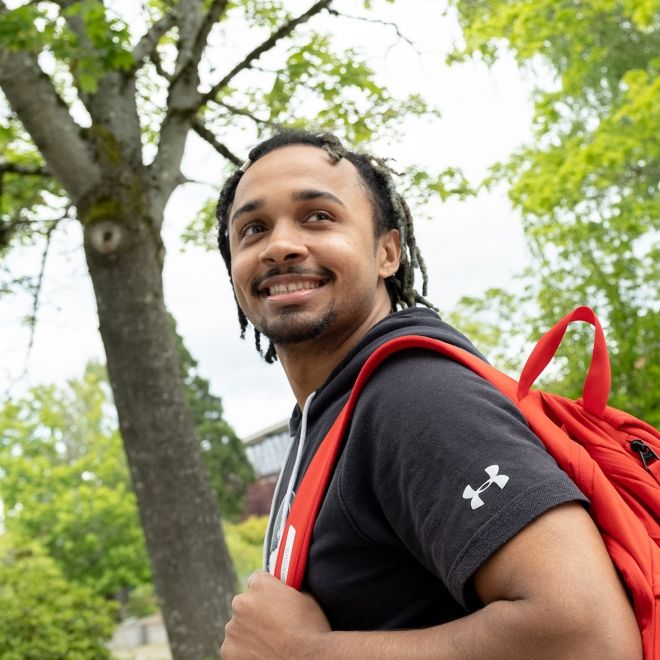 Student-Male-Backpack.jpg Male student with backpack outside.