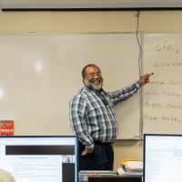 OC Professor Kevin Blackwell teaching a class, with two students in the foreground