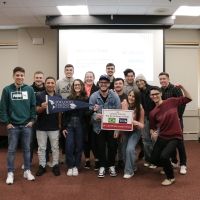 Students from OC and UNOESCO pose in a classroom.