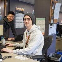 IT Help Desk staff sitting at computer