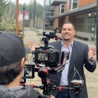 Student outdoors at Poulsbo Campus and posing for camera