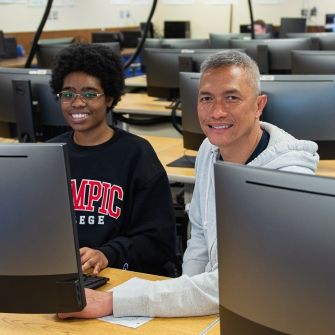 Students sitting behind computers in classroom