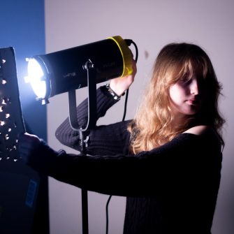 Film student with lighting equipment