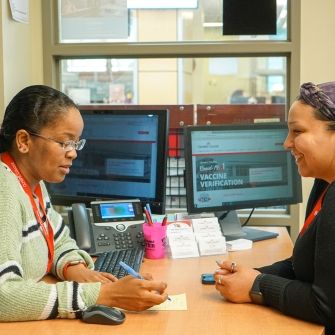 Student workers at a computer.