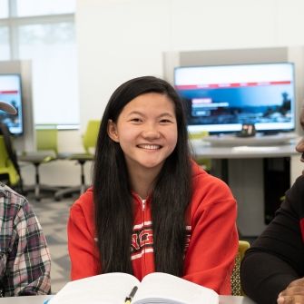 Students with book and laptop