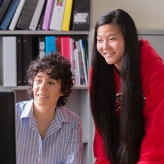 Teacher and student at computer