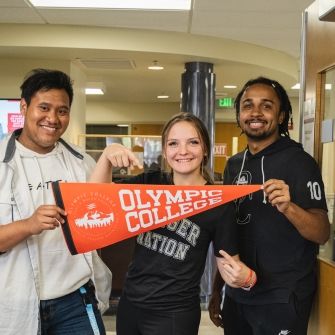 Three Students with Banner