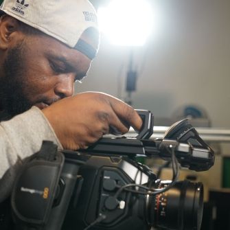 A student operating a video camera