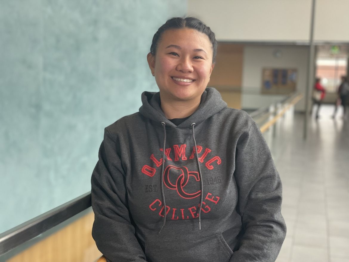 Smiling student in dark gray Olympic College sweatshirt in Bldg. 7