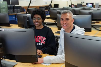 Students sitting behind computers in classroom