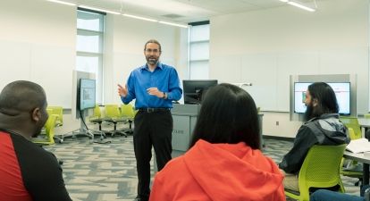 Male professor with students.