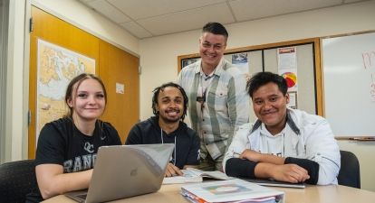 Three students with staff. 