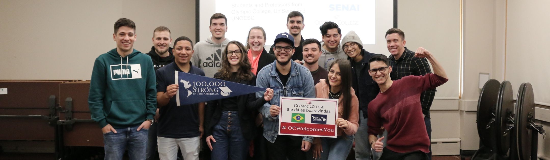 Students from OC and UNOESCO pose in a classroom.