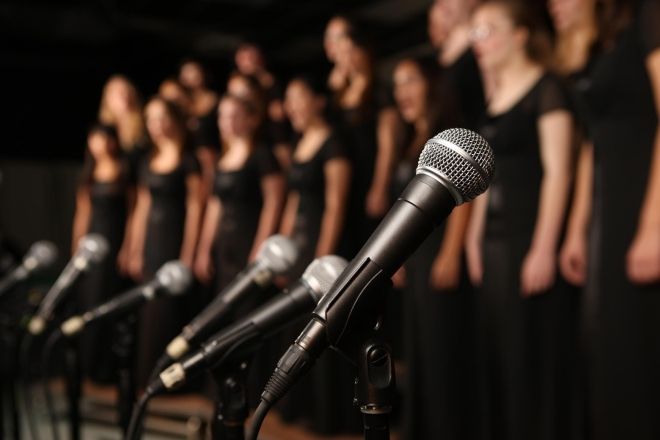 Choir students with microphones.