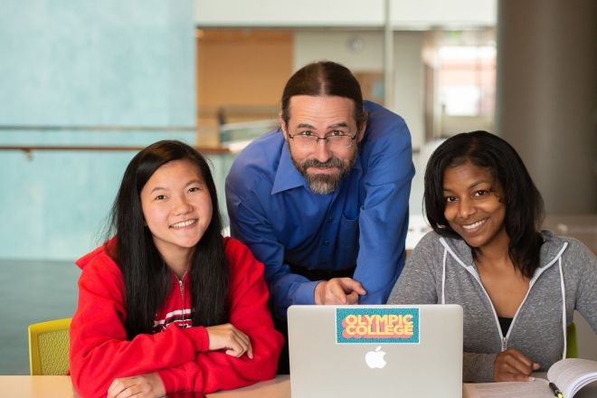 Two students with faculty member in middle.