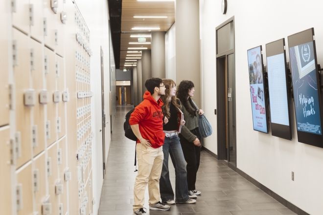Filmmaking students walking down hallway