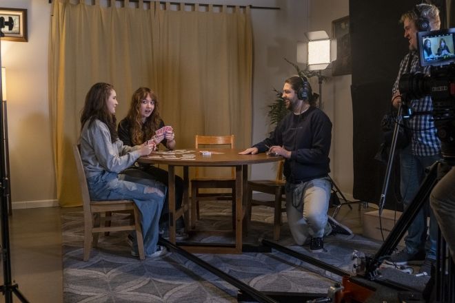 Filmmaking students filming a scene on sound stage