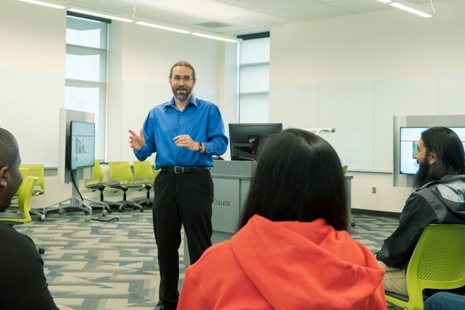 Male professor with students.