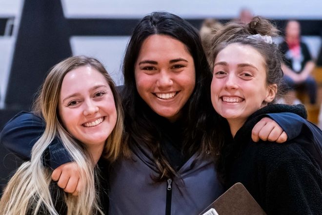 Three female students at event.