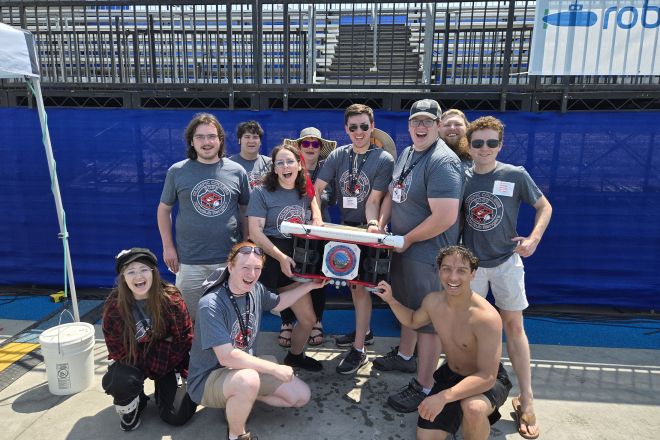 STEM students with robotic submarine at competition