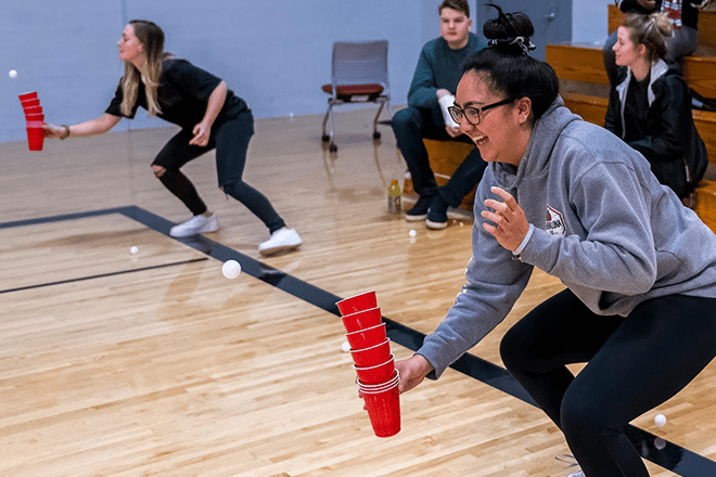 Students playing games in gym.
