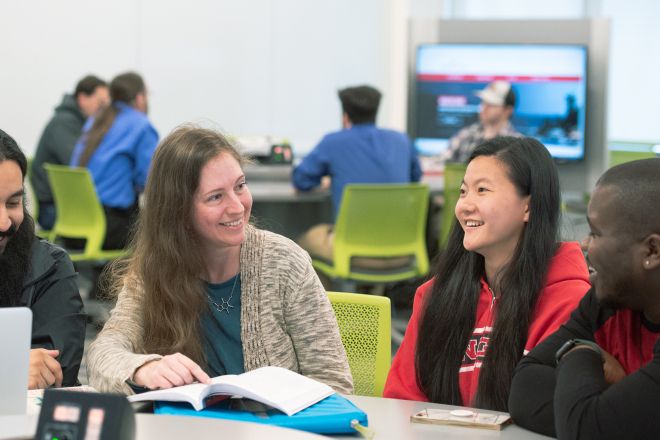 Student with teacher in classroom. 