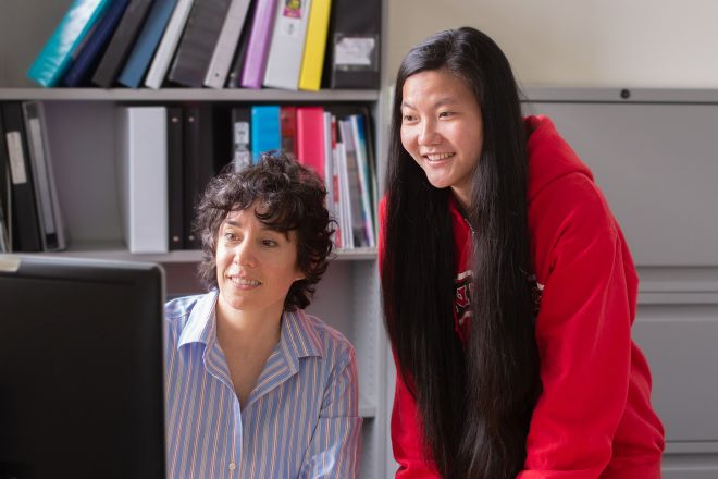 Teacher and student at computer