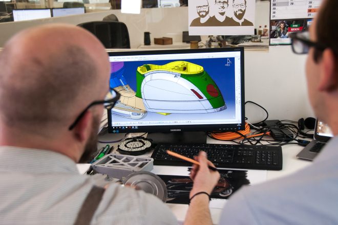 Student and teacher evaluate a 3D design on a computer