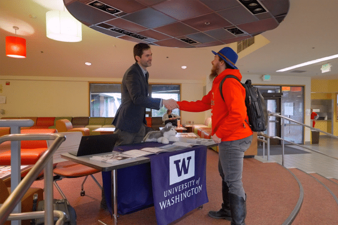 Advisor and student shaking hands
