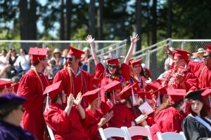 Group of Olympic College students in red regalia at graduation