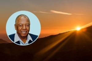 Yellow sunset peeking over a distant hill, with circle graphic containing the authors image.