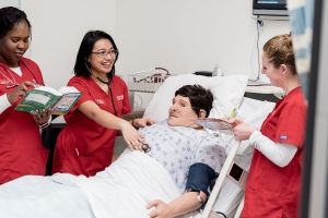 Three nursing students in simulation lab. 