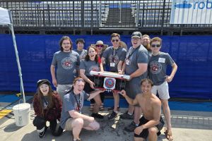 STEM students with robotic submarine at competition