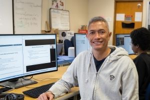 Male student at computer. 