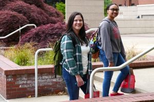Two students walking on campus.