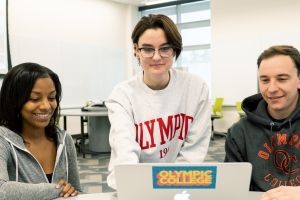 Three students at a laptop.