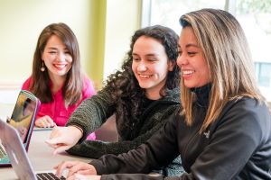 Three female students with laptops