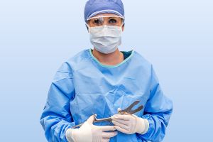 Surgical Technician holding tools for surgery