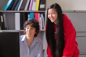 Teacher and student at computer