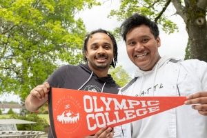 Two male students with OC pennant. 