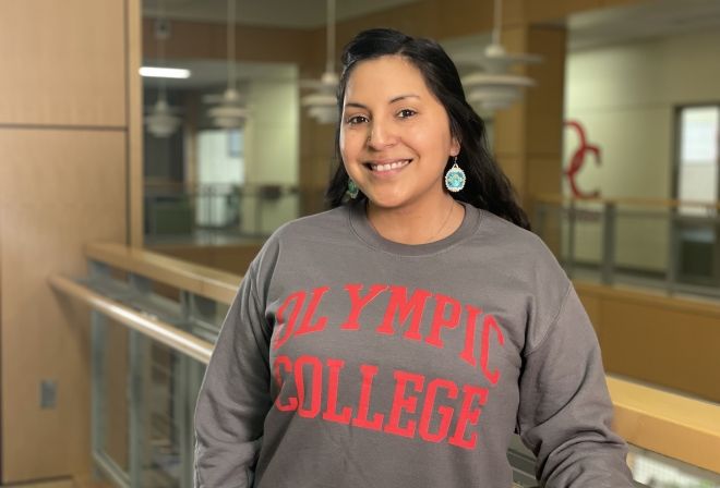 Smiling student in gray Olympic College sweatshirt, in Bldg. 4