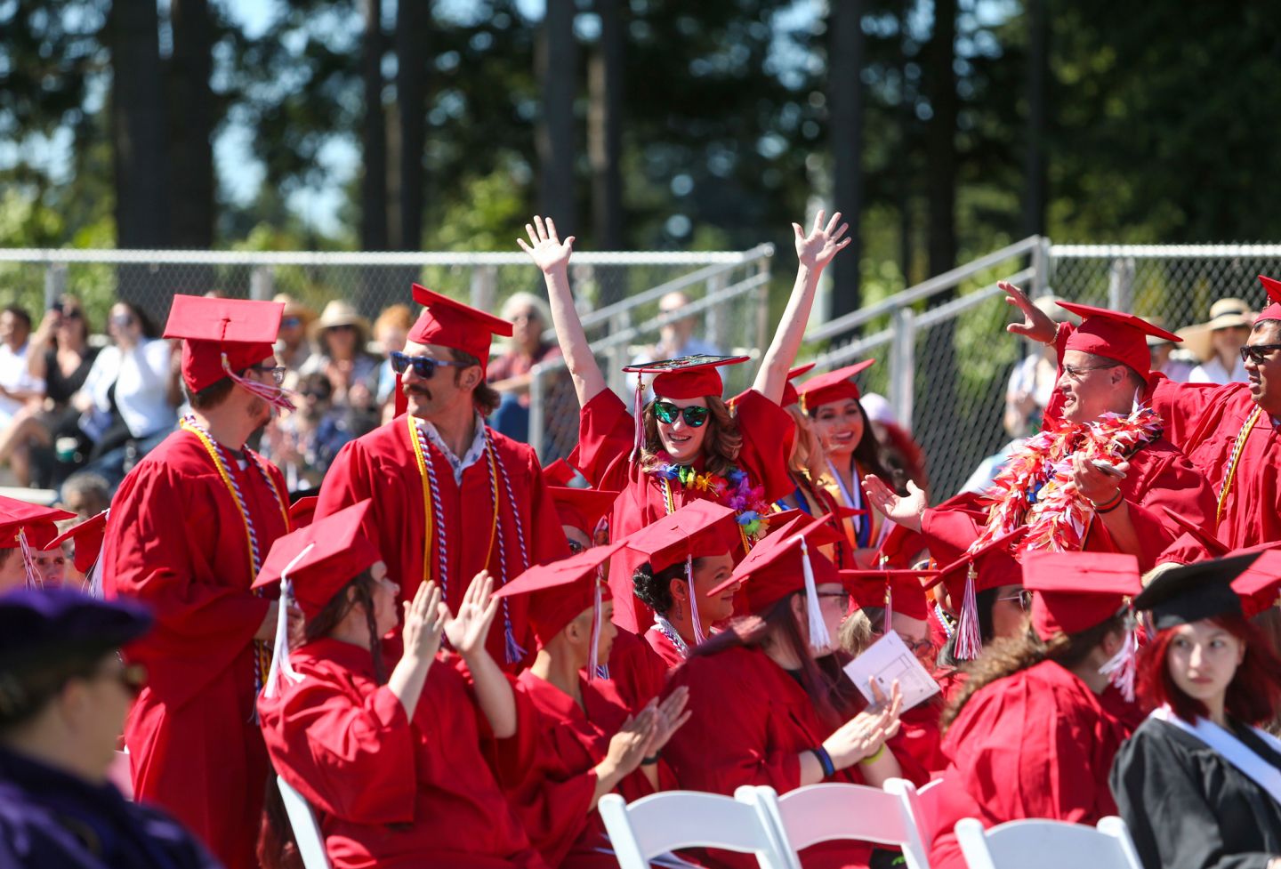 Group of Olympic College students in red regalia at graduation