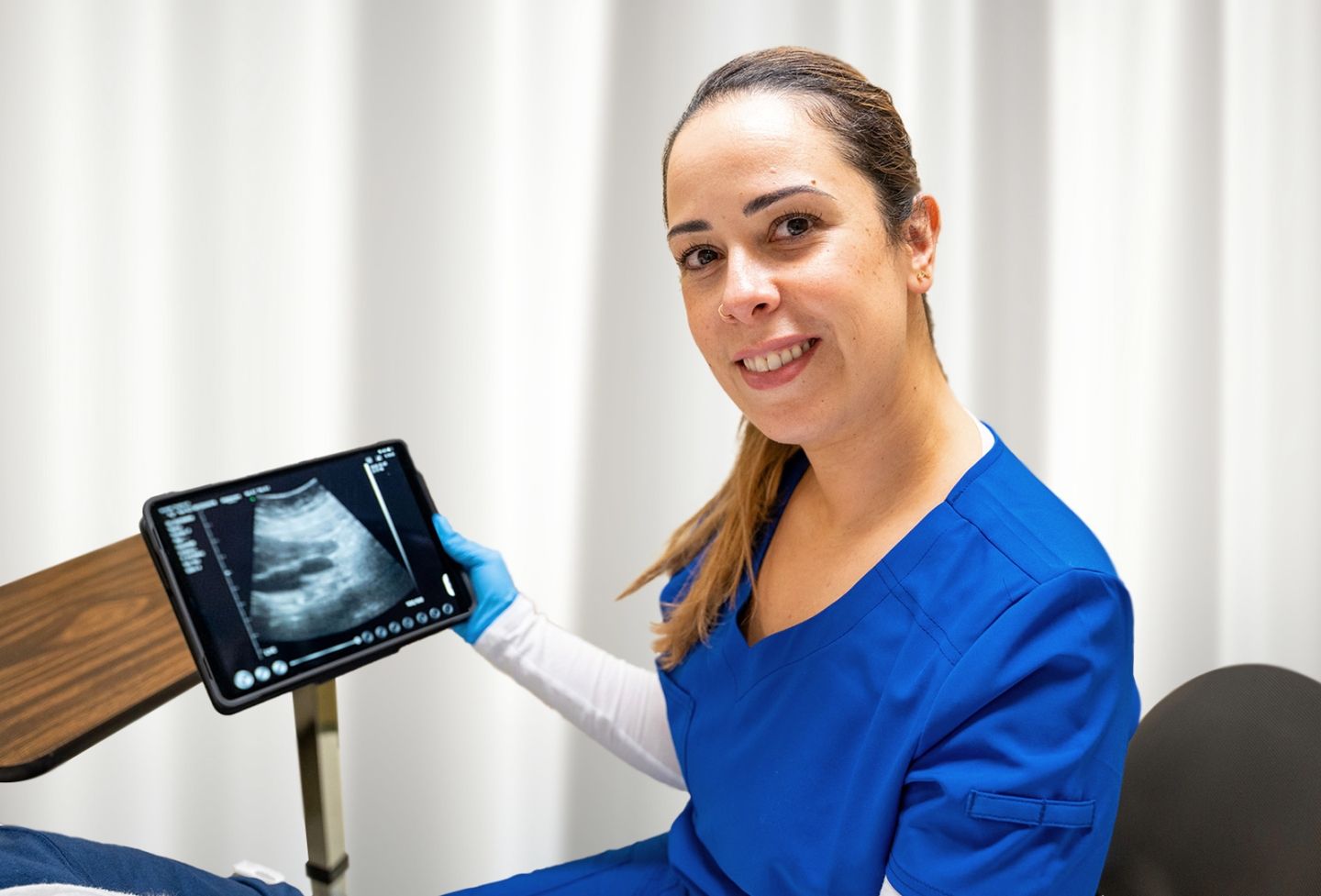 Female performing ultrasound.